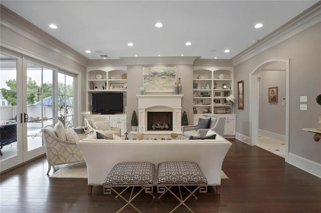 21 Royal Palm Dr, Kenner, LA 70065 - living area with ornamental molding, built in shelves, dark wood-style floors, arched walkways, and recessed lighting