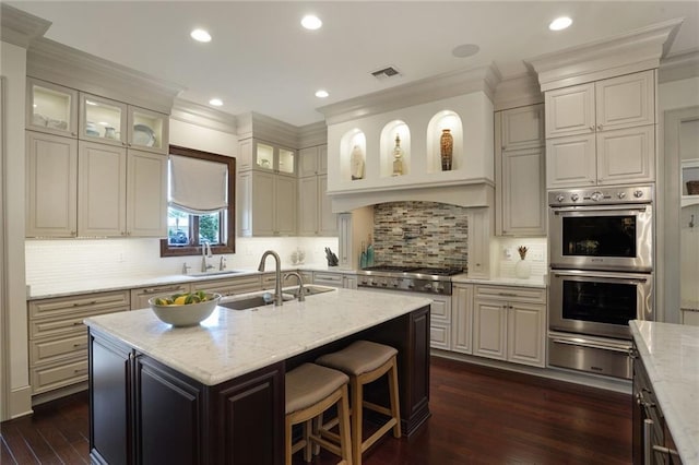 21 Royal Palm Dr, Kenner, LA 70065 - kitchen featuring stainless steel appliances, a warming drawer, crown molding, dark wood-style floors, and light stone counters