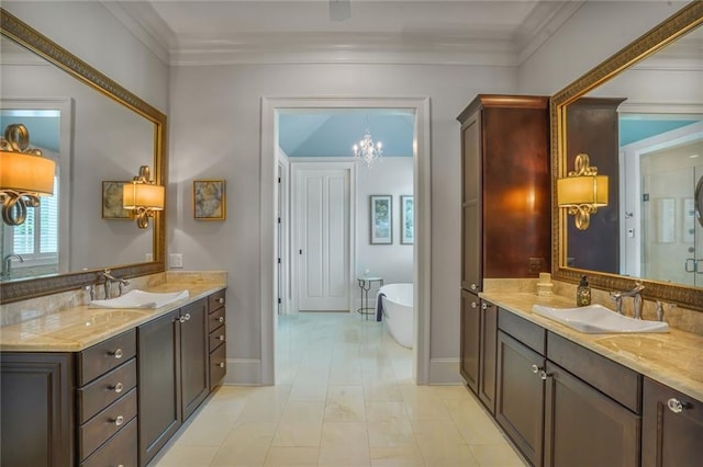 21 Royal Palm Dr, Kenner, LA 70065 - bathroom featuring a stall shower, a chandelier, two vanities, a soaking tub, and ornamental molding