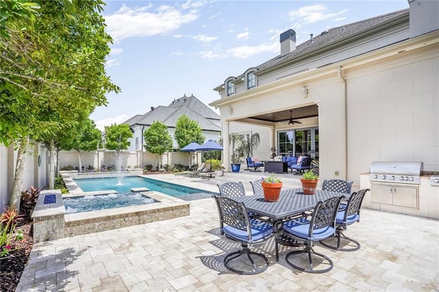 21 Royal Palm Dr, Kenner, LA 70065 - view of swimming pool with a patio area, a fenced backyard, a ceiling fan, an outdoor kitchen, and outdoor dining area