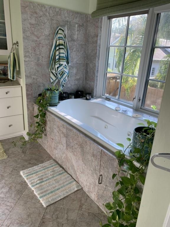 2527 Calhoun St, New Orleans, LA 70118 - bathroom featuring a tub with jets and vanity