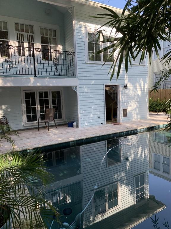 2527 Calhoun St, New Orleans, LA 70118 - back of property with a balcony, a patio, and an outdoor pool