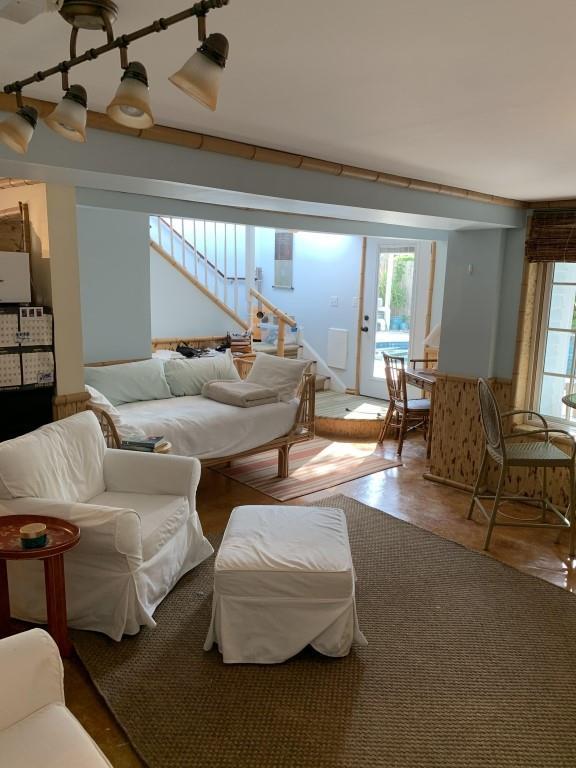 2527 Calhoun St, New Orleans, LA 70118 - living room featuring stairs and wood finished floors