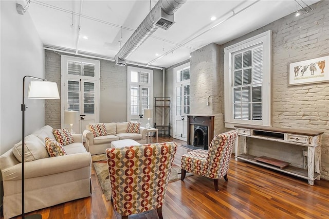 1140 Decatur St Unit 3, New Orleans, LA 70116 - living room featuring hardwood / wood-style floors and brick wall
