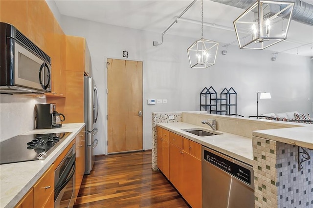 1140 Decatur St Unit 3, New Orleans, LA 70116 - kitchen featuring appliances with stainless steel finishes, dark wood-type flooring, light countertops, and a chandelier