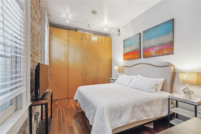 1140 Decatur St Unit 3, New Orleans, LA 70116 - bedroom featuring wood finished floors, track lighting, and a closet