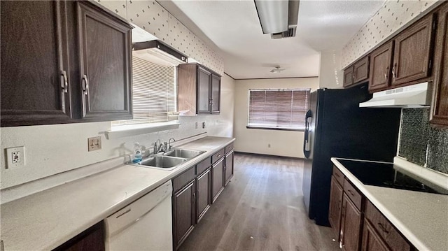 5761 Carlisle Ct, New Orleans, LA 70131 - kitchen featuring under cabinet range hood, white dishwasher, light wood-type flooring, black electric stovetop, and dark brown cabinetry