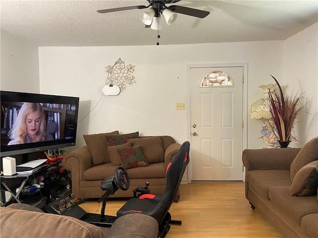8007 Drum St, New Orleans, LA 70126 - living room featuring light wood-style floors, a ceiling fan, and a textured ceiling