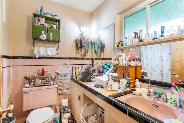 1435 Monterrey Blvd, Baton Rouge, LA 70815 - bathroom featuring a textured wall, tile walls, and vanity