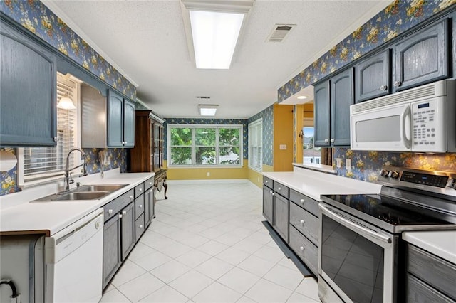 422 Eden Isles Blvd, Slidell, LA 70458 - kitchen featuring white appliances, light countertops, decorative backsplash, light tile patterned flooring, and a textured ceiling