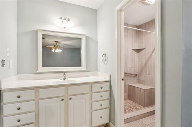 422 Eden Isles Blvd, Slidell, LA 70458 - bathroom with a tile shower, vanity, and a ceiling fan