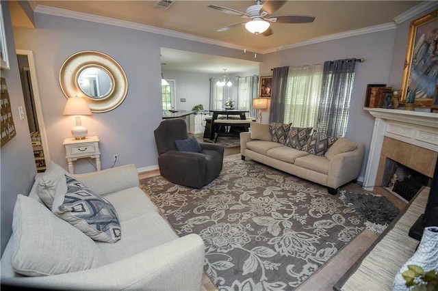 43126 Pecan Ridge Dr, Hammond, LA 70403 - living room with ceiling fan, crown molding, wood finished floors, a fireplace, and a chandelier