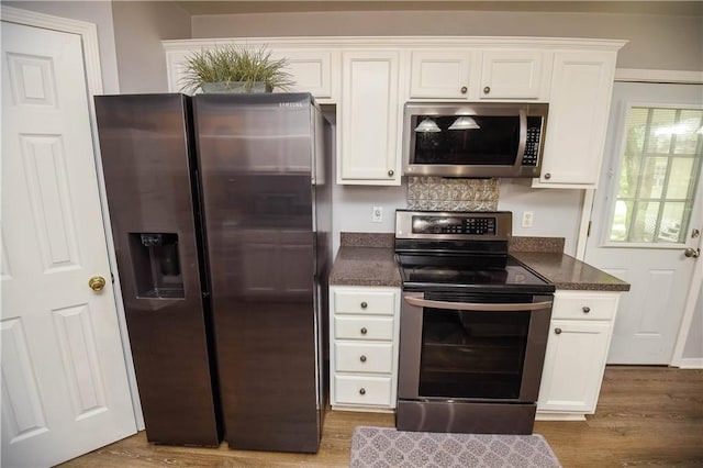 43126 Pecan Ridge Dr, Hammond, LA 70403 - kitchen with stainless steel appliances, wood finished floors, and white cabinetry