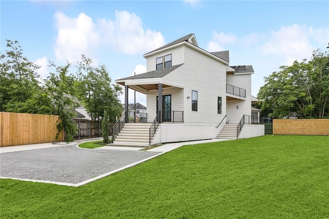 5651 W End Blvd, New Orleans, LA 70124 - back of property featuring stairway, roof with shingles, and a balcony