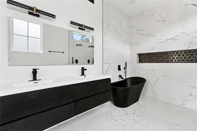 5651 W End Blvd, New Orleans, LA 70124 - full bath with double vanity, a freestanding tub, marble tiled floors, and stone wall