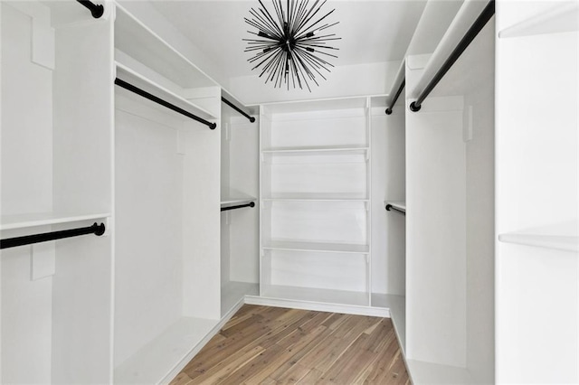 5651 W End Blvd, New Orleans, LA 70124 - spacious closet with wood finished floors, a barn door, and a chandelier