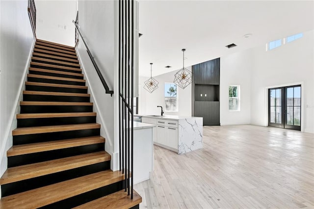 5651 W End Blvd, New Orleans, LA 70124 - stairway with a high ceiling and wood finished floors