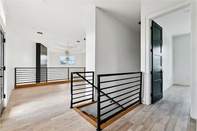 5651 W End Blvd, New Orleans, LA 70124 - hall with an upstairs landing, a chandelier, and wood finished floors