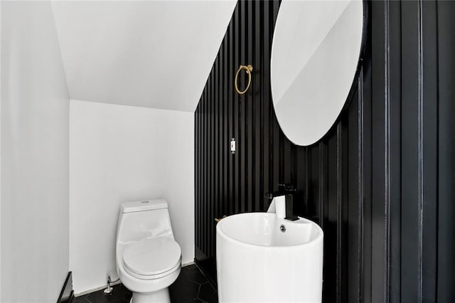 5651 W End Blvd, New Orleans, LA 70124 - half bathroom with tile patterned flooring and an accent wall