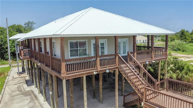 121 Pontchartrain Rd, La Place, LA 70068 - view of front of home featuring stairs, french doors, a metal roof, and covered porch