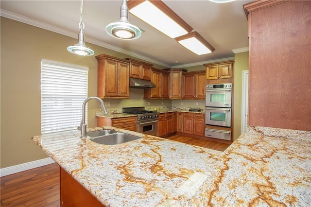 121 Pontchartrain Rd, La Place, LA 70068 - kitchen featuring stainless steel appliances, a warming drawer, under cabinet range hood, ornamental molding, and brown cabinets