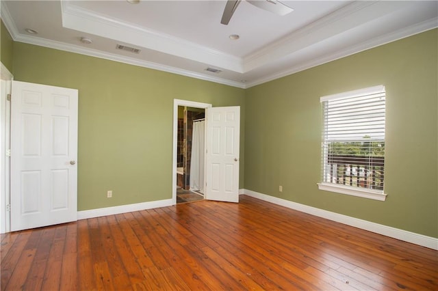 121 Pontchartrain Rd, La Place, LA 70068 - unfurnished bedroom with a tray ceiling, wood-type flooring, crown molding, ceiling fan, and ensuite bathroom