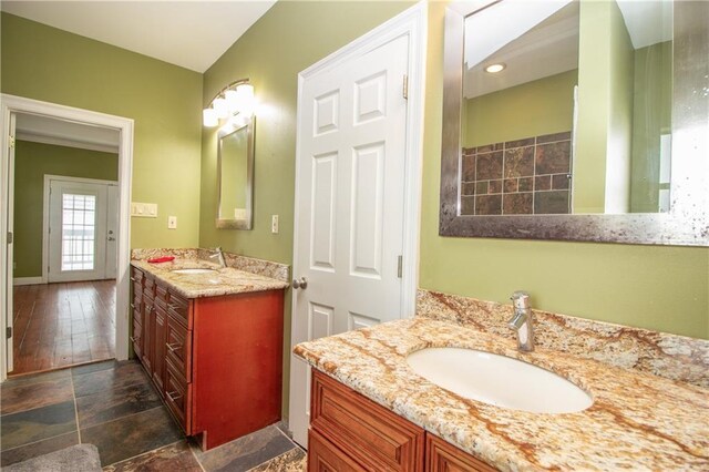 121 Pontchartrain Rd, La Place, LA 70068 - bathroom featuring two vanities and baseboards