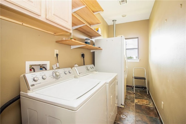 121 Pontchartrain Rd, La Place, LA 70068 - laundry room featuring cabinet space, dark stone finish floors, and washing machine and dryer