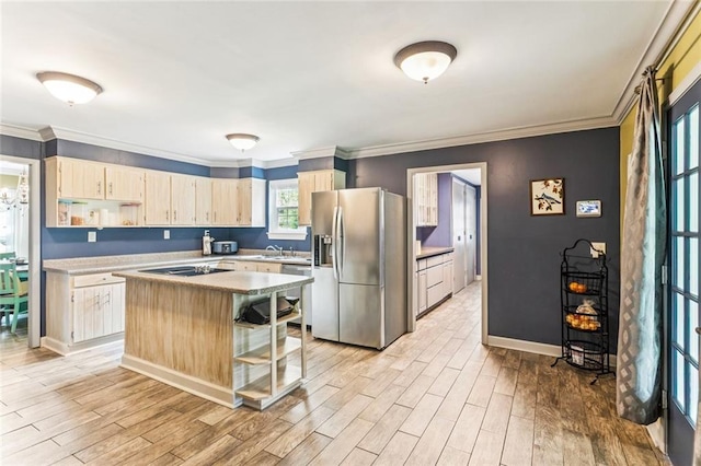 314 Royal Dr, Slidell, LA 70460 - kitchen featuring appliances with stainless steel finishes, light countertops, a kitchen island, light wood finished floors, and crown molding