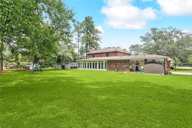314 Royal Dr, Slidell, LA 70460 - back of house featuring brick siding, a lawn, a storage unit, and a chimney