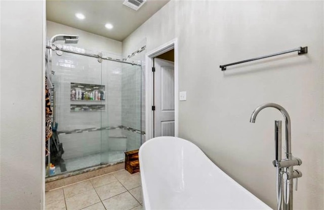 10596 Braves Ave, Denham Springs, LA 70726 - full bath with tile patterned flooring, a stall shower, a freestanding bath, and recessed lighting