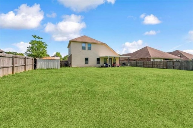 10596 Braves Ave, Denham Springs, LA 70726 - rear view of property with a fenced backyard and a storage unit