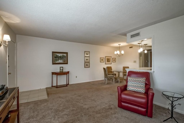 2708 Whitney Pl Unit 901, Metairie, LA 70002 - living area featuring a chandelier, a textured ceiling, and carpet flooring