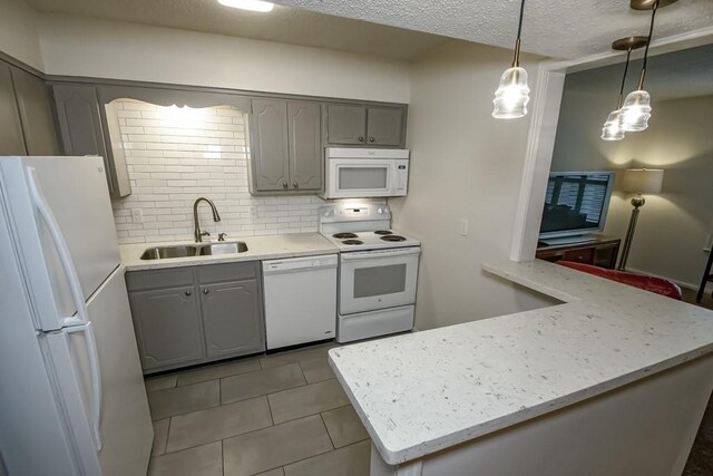 2708 Whitney Pl Unit 901, Metairie, LA 70002 - kitchen featuring white appliances, gray cabinets, tile patterned floors, tasteful backsplash, and a textured ceiling