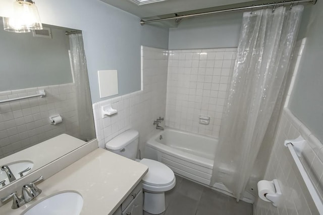 2708 Whitney Pl Unit 901, Metairie, LA 70002 - bathroom with tile walls, shower / tub combo, vanity, wainscoting, and tile patterned flooring