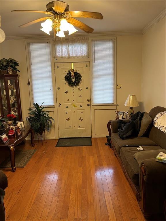 242830 A P Tureaud Ave, New Orleans, LA 70119 - entryway featuring ceiling fan, light wood-style flooring, and ornamental molding