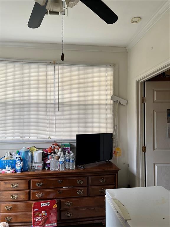 242830 A P Tureaud Ave, New Orleans, LA 70119 - bedroom featuring crown molding and a ceiling fan