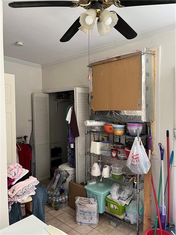 242830 A P Tureaud Ave, New Orleans, LA 70119 - kitchen featuring tile patterned floors, crown molding, and a ceiling fan