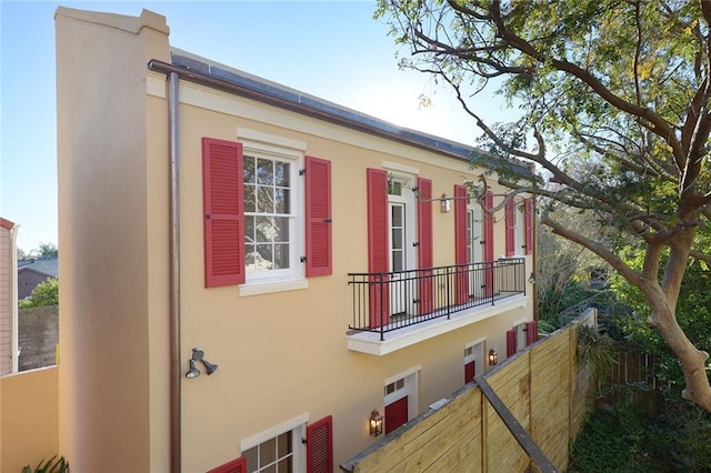 826 Touro St Unit 4, New Orleans, LA 70116 - view of home's exterior featuring stucco siding and a balcony
