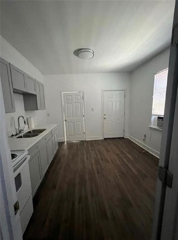 2905-07 Pauger St, New Orleans, LA 70119 - kitchen with white range with electric stovetop, dark wood-style flooring, light countertops, gray cabinets, and cooling unit