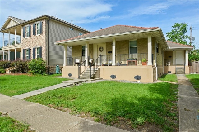 685759 Vicksburg St, New Orleans, LA 70124 - view of front of home with covered porch, a front yard, and brick siding
