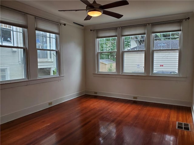 411 Lowerline St Unit D, New Orleans, LA 70118 - empty room with healthy amount of natural light, dark wood-style flooring, and a ceiling fan