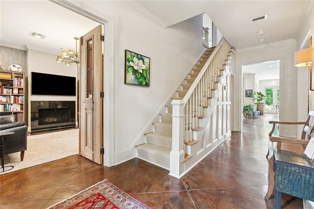 502 Hector Ave, Metairie, LA 70005 - staircase with crown molding, a fireplace, and a chandelier