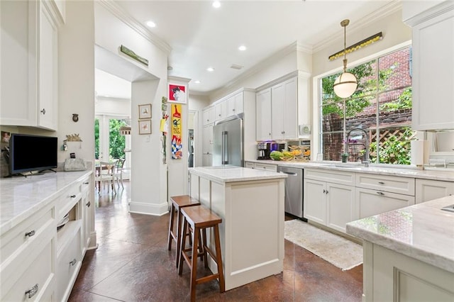 502 Hector Ave, Metairie, LA 70005 - kitchen featuring stainless steel appliances, ornamental molding, a kitchen island, recessed lighting, and white cabinets