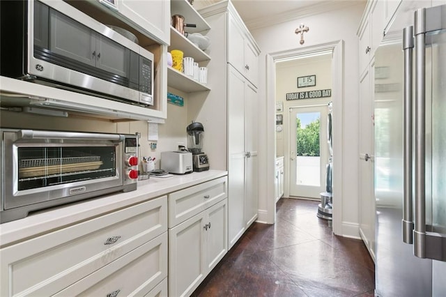 502 Hector Ave, Metairie, LA 70005 - kitchen featuring stainless steel appliances, open shelves, crown molding, light countertops, and white cabinetry