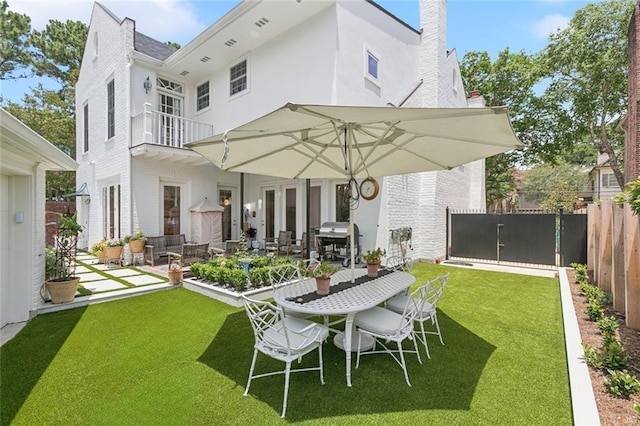 502 Hector Ave, Metairie, LA 70005 - rear view of property featuring a balcony, brick siding, a patio, outdoor dining space, and a chimney