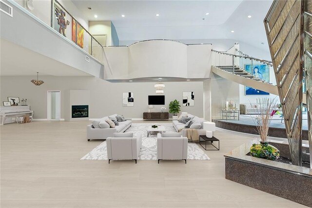 738 English Turn Ln, New Orleans, LA 70131 - living room with a high ceiling, stairway, and recessed lighting