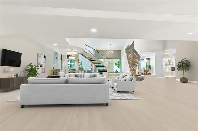 738 English Turn Ln, New Orleans, LA 70131 - living area featuring a chandelier, stairway, light wood finished floors, and recessed lighting