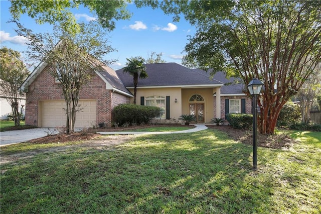 1071 Rue Chinon, Mandeville, LA 70471 - view of front of property featuring brick siding, a front yard, a garage, and french doors