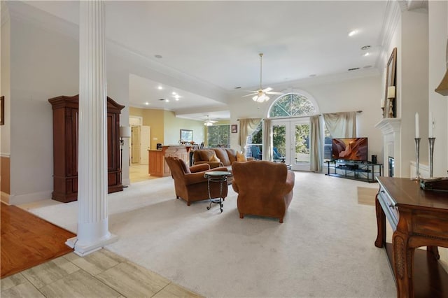 1071 Rue Chinon, Mandeville, LA 70471 - living area with decorative columns, a ceiling fan, ornamental molding, light carpet, and a fireplace